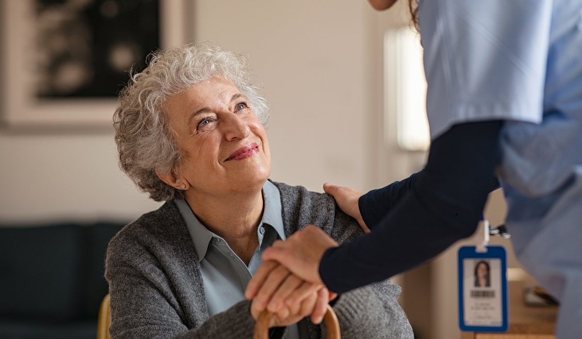 Senior receiving compassionate care from a nurse in a warm, welcoming environment at Lamset Hayah