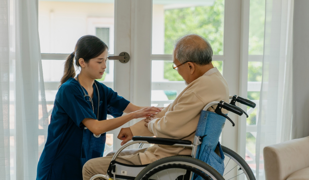 Elderly woman smiling while chatting with family members, representing the value of social interaction for older adults.