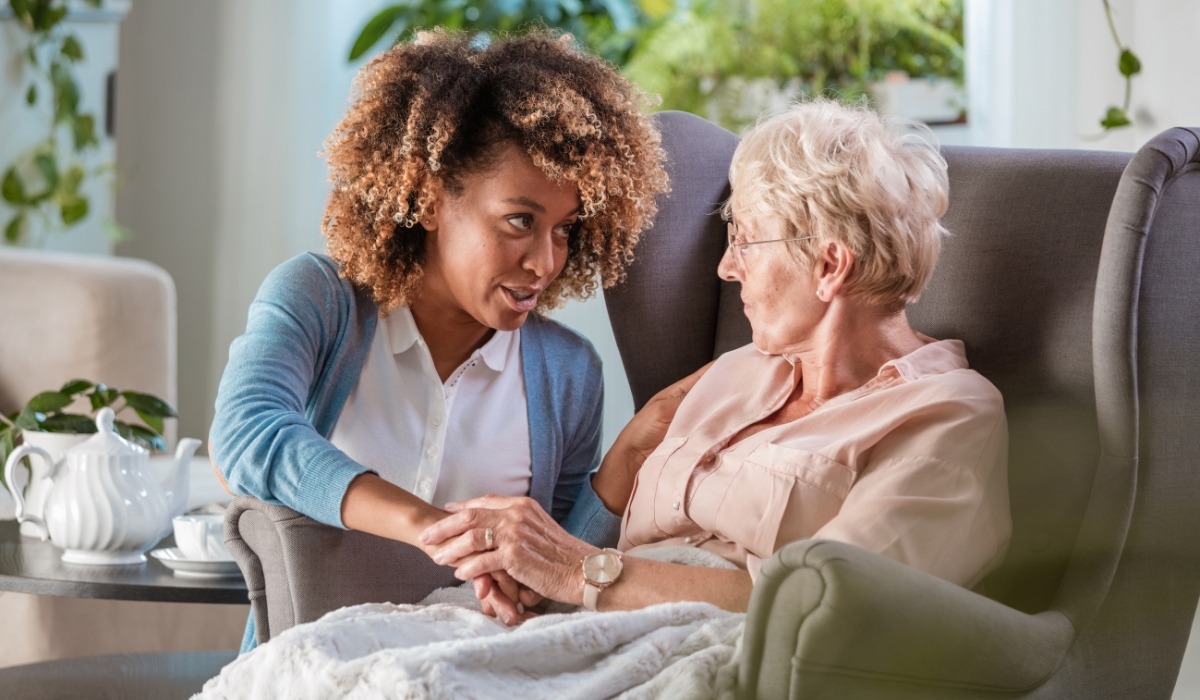 Senior woman engaging in a memory game with a caregiver, highlighting the importance of mental and cognitive activities