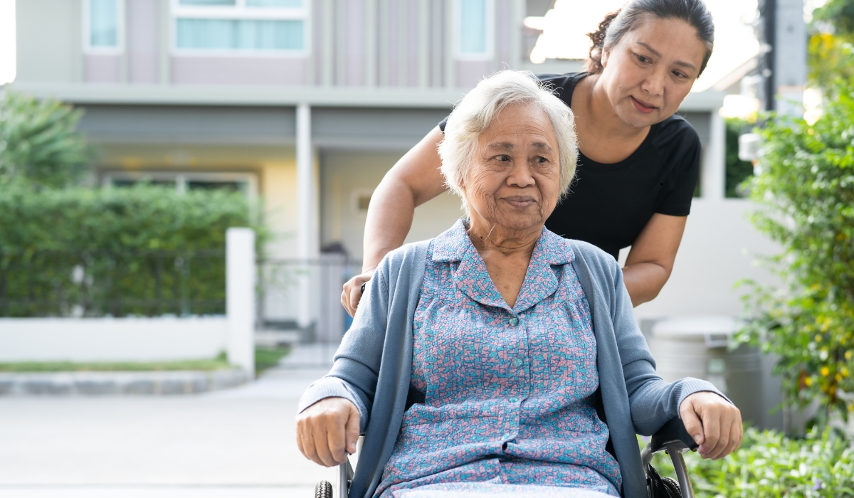 An elderly woman receiving attentive medical care from a compassionate nurse, illustrating the importance of specialized elderly care.